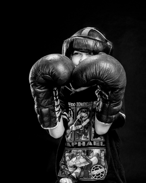 image of young child wearing boxing gloves